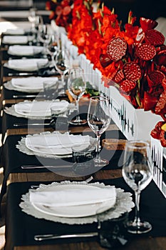 Tableware Glasses, flower fork, knife served for dinner in restaurant with cozy interior