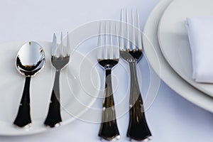 Tableware Glasses, flower fork, knife served for dinner in restaurant with cozy interior