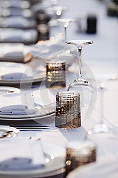 Tableware Glasses, flower fork, knife served for dinner in restaurant with cozy interior