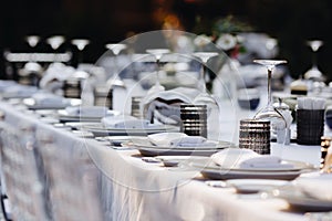 Tableware Glasses, flower fork, knife served for dinner in restaurant with cozy interior