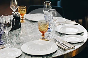 Tableware Glasses, flower fork, knife served for dinner in restaurant with cozy interior