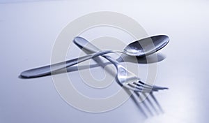 Fork and a spoon in a white background