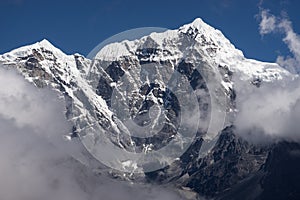 Taboche mountain peak above the clouds, Everest region, Nepal