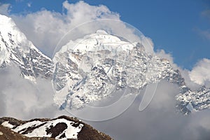 Taboche Peak mountain summit in clouds in Himalayas