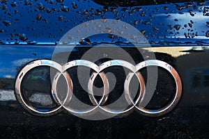 Audi company logo on wet car