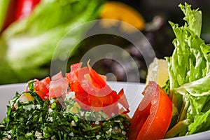 TABOULA or tabouleh salad with tomato and leaves served in dish close up side view of arab food