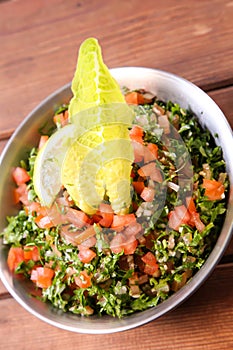 Taboula or tabouleh and tabbouleh salad served in dish isolated on background top of arabic food cold mezza photo