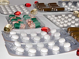 Tabs Vitamins, omega 3, Medications tablets and capsules in a beaker.