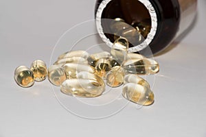 Tabs Vitamins, omega 3, Medications tablets and capsules in a beaker.