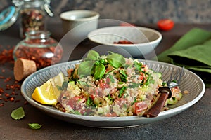 Tabule - a traditional oriental salad with vegetables, parsley and spices photo