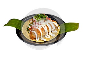 Taco condesa with fried fish on black plate isolated on white background site view photo