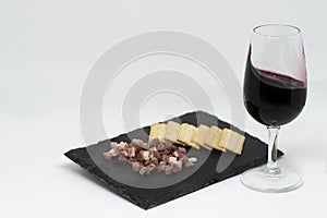 Taco ham and red wine in glass cup. Tempranillo grape variety and Cabernet sauvignon. Wine made in Spain photo