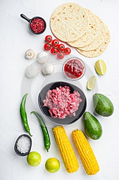 Taco ingredients homemade authentic mexican beef meal, over white concrete background top view