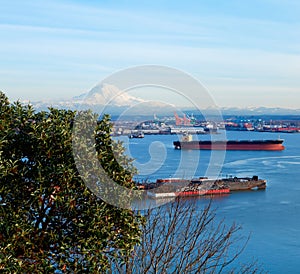 Tacoma port with cargo ships and Volcano Mt. Ranier.