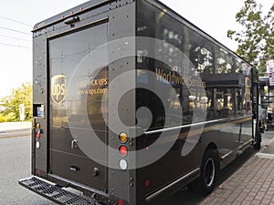 Tacoma, WA USA - circa August 2021: View of a brown UPS delivery truck parked on the side of a street downtown