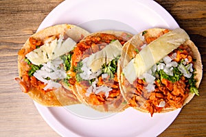 Tacos al pastor with corn tortillas. Mexican food. Mexican food concept on wooden table. Traditional Mexican food