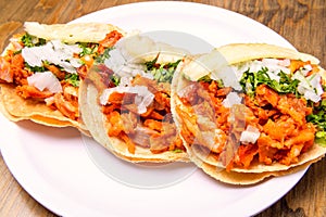 Tacos al pastor with corn tortillas. Mexican food. Mexican food concept on wooden table. Traditional Mexican food