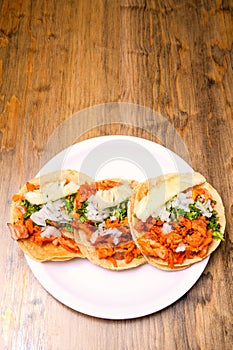 Tacos al pastor with corn tortillas. Mexican food. Mexican food concept on wooden table. Traditional Mexican food