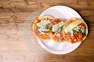 Tacos al pastor with corn tortillas. Mexican food. Mexican food concept on wooden table. Traditional Mexican food