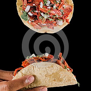 Tacos al pastor design composition on a black background, with a person squeezing lime on it.