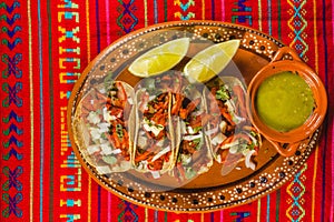 Tacos al pastor and lemons green sauce mexican spicy food in mexico city photo