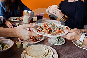Tacos al Pastor in a Mexican Taqueria, hands holding Traditional food in Mexico photo