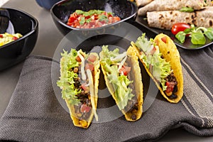 Tacos with beef on gray table