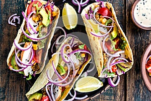 Tacos with chicken meat, vegetables and fresh greens