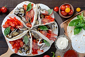 Tacos is a traditional Mexican snack. Eggplants, sweet peppers, tomatoes in pita bread.