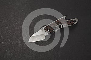 tactical folding knife. EDC knife. on dark background