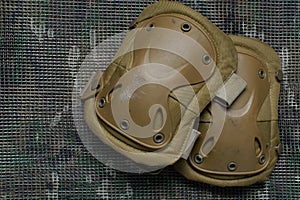 Tactical knee pads lies on a multicam background