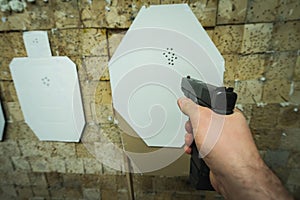 Tactical pistol shooting at a paper target at a shooting range. 3d view