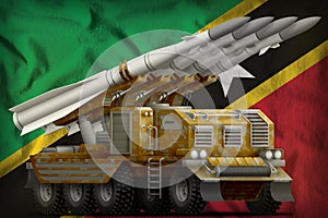 Tactical short range ballistic missile with sand camouflage on the Saint Kitts and Nevis national flag background. 3d Illustration