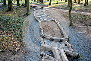 Tactile path for bare feet awakens senses and uneven endings on the feet alternating different materials wood stone gravel