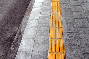 Tactile paving for blind handicap on tiles pathway.