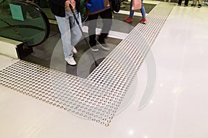 Tactile paving path for the blind entrance exit of escalator photo
