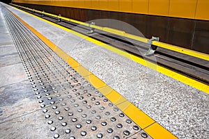 tactile paving for visually impared at subway platform edge. yel photo