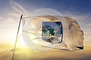 Tacuarembo Department of Uruguay flag textile cloth fabric waving on the top sunrise mist fog photo