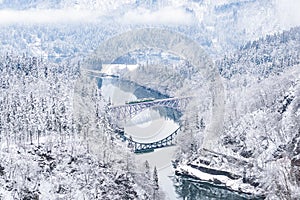 Tadami Line Train across Tadami River in Winter, Fukushima, Japan