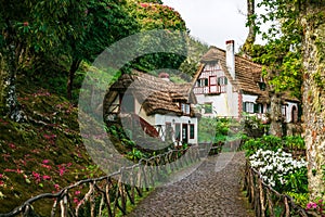 Taditional houses in Queimadas Forest Park in Santana, Madeira near Caldeirao Verde waterfall, Portugal