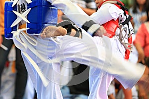 Taekwondo athletes fighting on stage