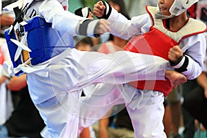 Taekwondo athletes fighting on stage