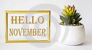 Tag with the words hello october in a gold frame on a white background