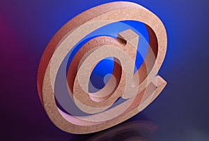 Tagging Email Symbol made with Wooden letter on color light backgronud.