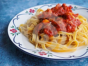 Tagliatelle pasta with chicken tomato sauce.