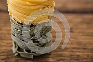 Tagliatelle pasta on wooden surface