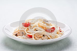 Tagliatelle sauted with tomatoes and mushrooms photo