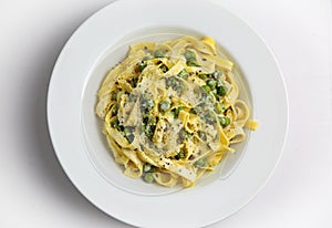 Tagliatelli con Limone e Piselli on white plate