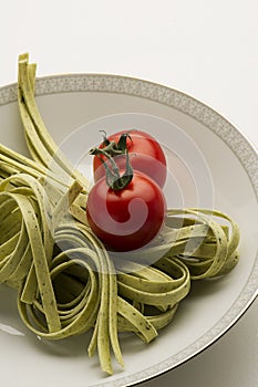 Tagliatelli pasta and fresh tomatoes photo