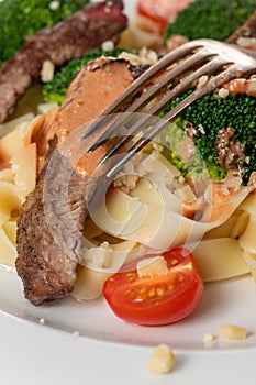 tagliatelli with steak slices photo